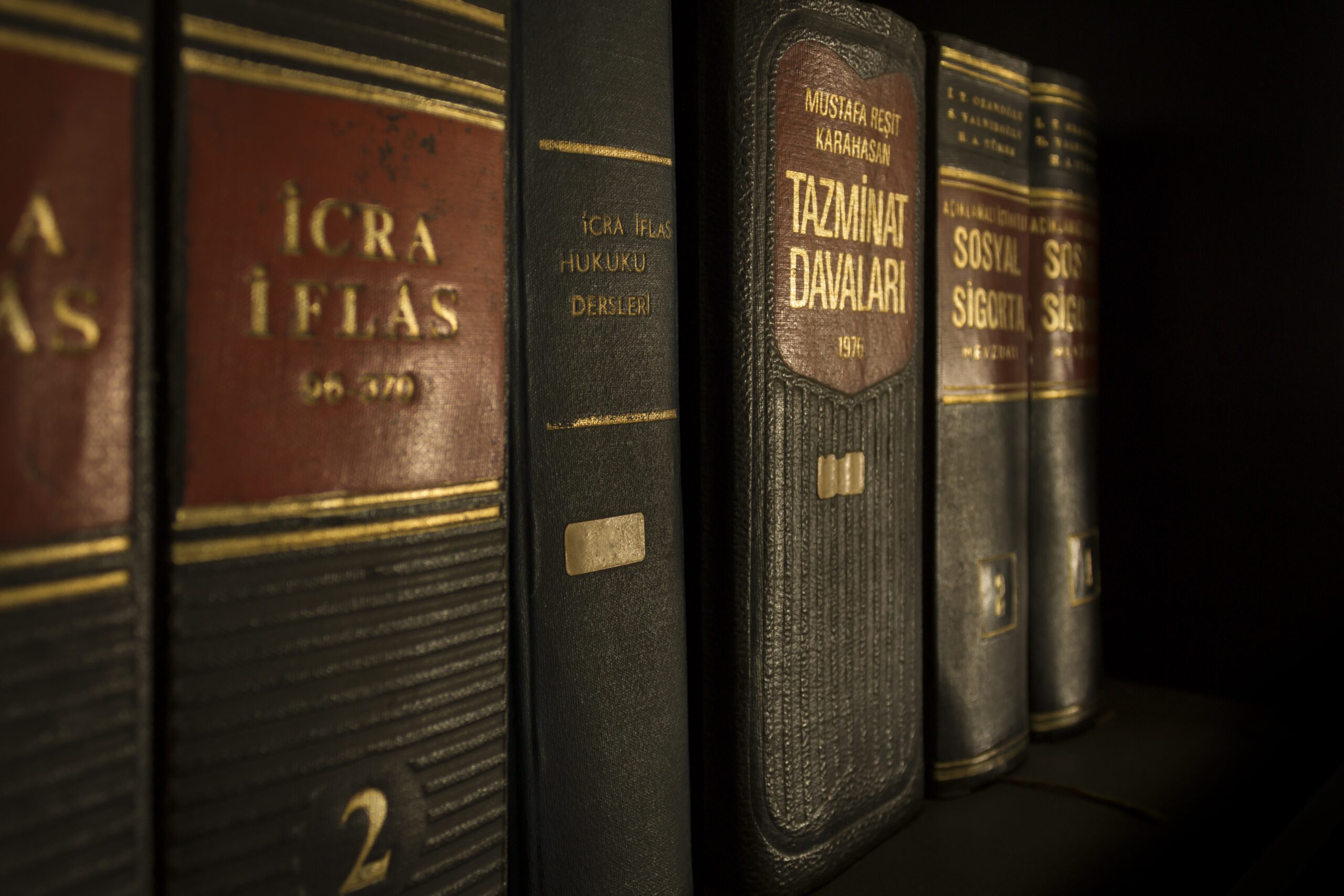 collection of leather-bound books on shelf