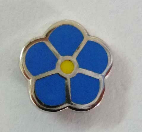 Traditional Masonic Forget-Me-Not pin with five blue petals surrounding a yellow center and silver accents