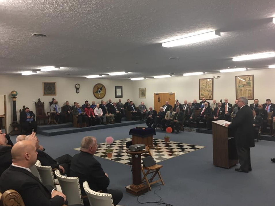 Ohio Grand Master Keith Newton stands at a podium and addresses the Masons of the 8th District of Ohio