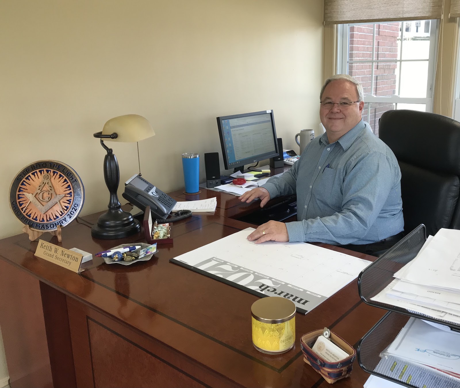 Ohio Freemasonry’s Grand Secretary, Brother Keith Newton, Most Worshipful Past Grand Master seated as his desk.