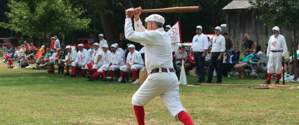 Vintage 1869 Cincinnati Redstocking team playing a baseball game in Ohio Caption: Vintage 1869 Cincinnati Redstocking team in action.