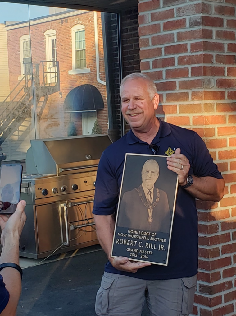 Image of Masonic Grand Master receiving celebratory plaque.