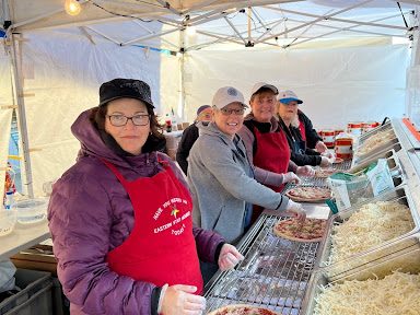 Image of women from OES making sauerkraut pizza’s at the Waynesville Sauerkraut festival.