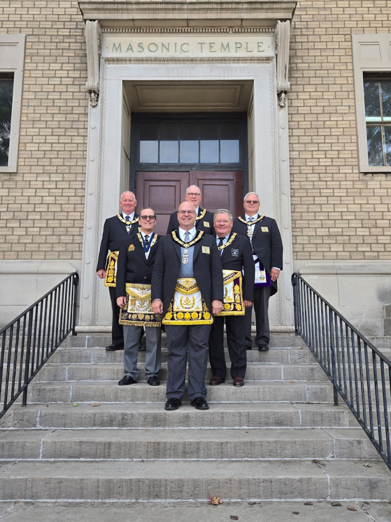 Ohio Grand Masters, Past and Present, standing in a arrowhead formation on stairs.