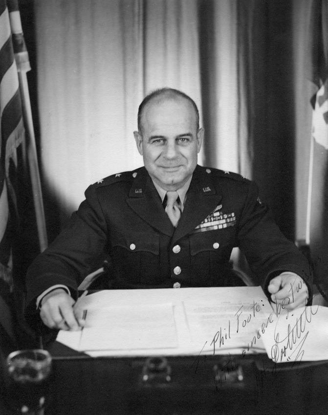 Autographed photo of General Jimmy Doolittle sitting at a desk
