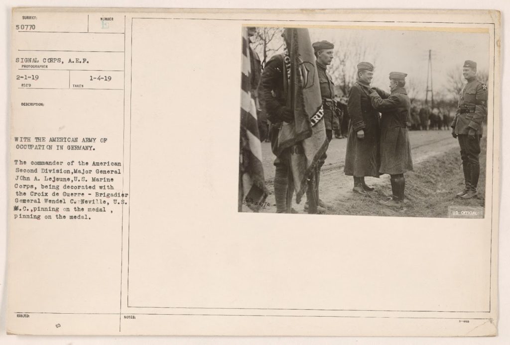 An archival photo featuring General John A. Lejeune being decorated with the Croix de Guerre